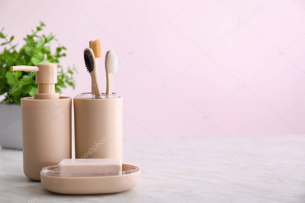 Toothbrushes with soap on table in bathroom
