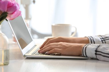 Masada dizüstü bilgisayarda çalışan genç kadın