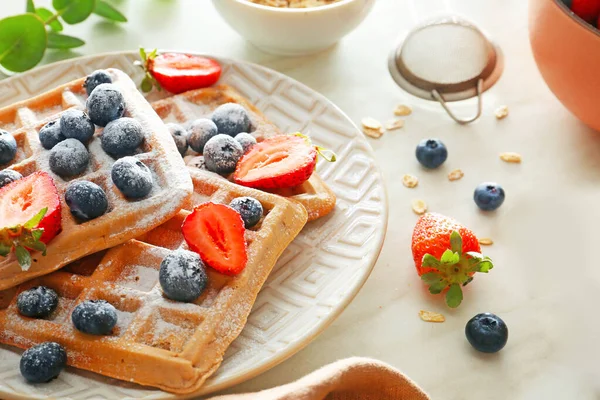 Plate with sweet tasty waffles and berries on table — Stock Photo, Image