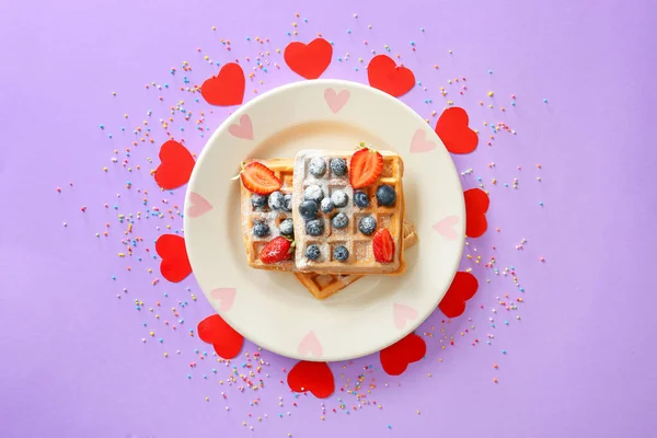 Plate with sweet tasty waffles and berries on color background — Stock Photo, Image