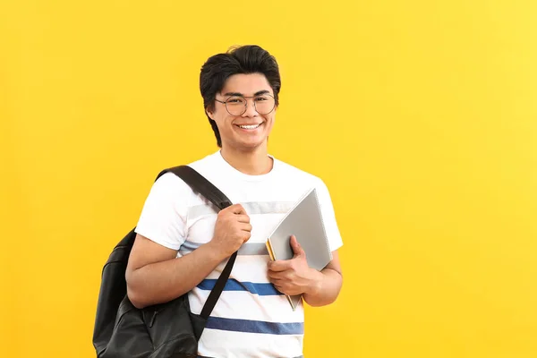 Retrato de estudante asiático bonito em fundo de cor — Fotografia de Stock