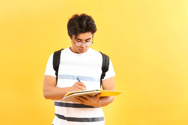 Portrait of handsome Asian student on color background — Stok Foto