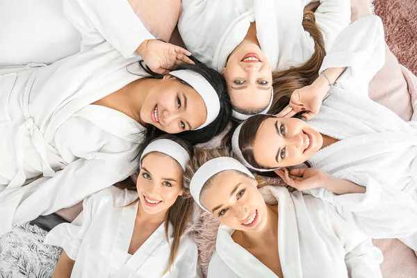 Happy young women lying on bed during hen party, top view — Stock Photo, Image