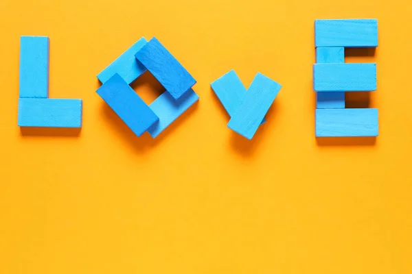 Word LOVE made of blocks on color background — Stock Photo, Image