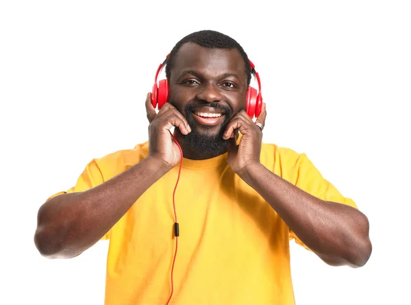 Handsome African-American man listening to music on white background — Stock Photo, Image