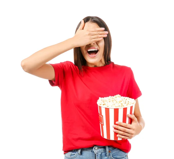Afraid woman with popcorn on white background — Stock Photo, Image