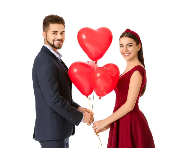 Portrait of beautiful young couple with air balloons on white background — Stock Photo, Image