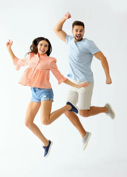 Ritratto di salto giovane coppia su sfondo bianco — Foto Stock