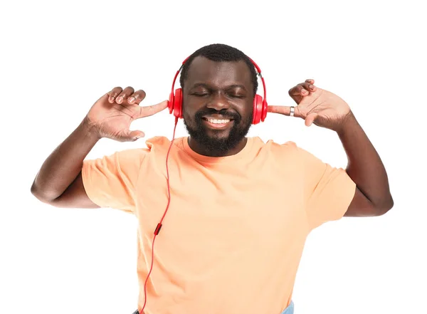 Handsome African-American man listening to music on white background — Stock Photo, Image