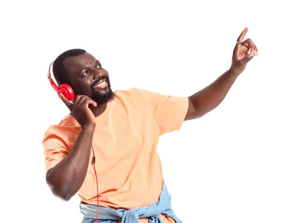 Handsome African-American man listening to music on white background — Stock Photo, Image