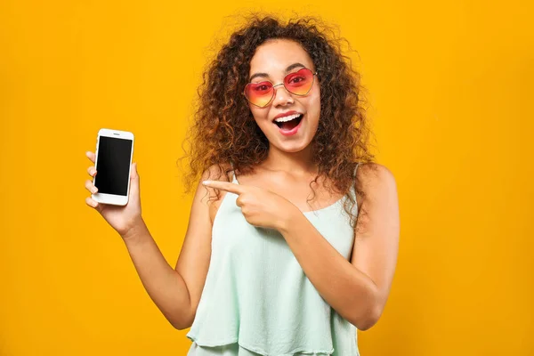 Portrait of happy African-American woman with mobile phone on color background — Stock Photo, Image