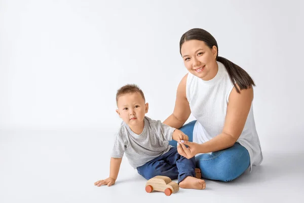 Portrait of Asian mother with cute baby boy on white background — Stock Photo, Image