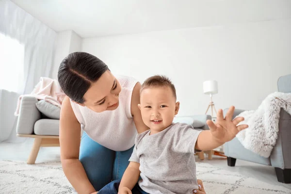 Happy Asian mother and cute little baby at home — Stock Photo, Image