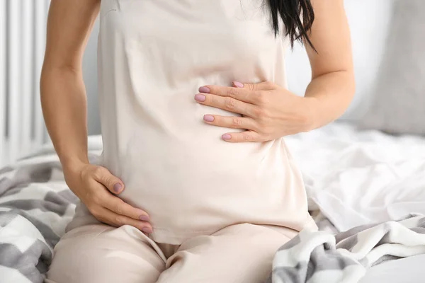 Beautiful young pregnant woman in bedroom, closeup — Stock Photo, Image