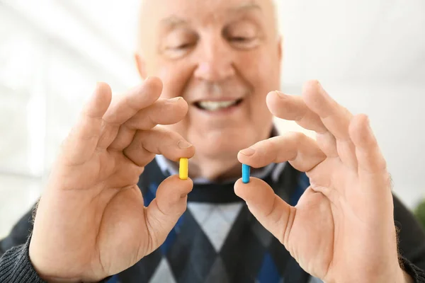 Elderly man with pills at home — Stock Photo, Image