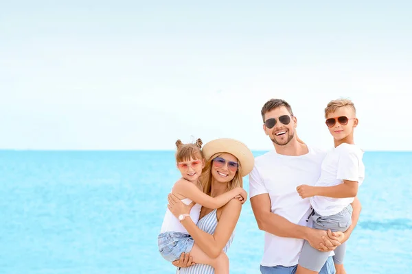 Portrait of happy family on sea beach — Stock Photo, Image