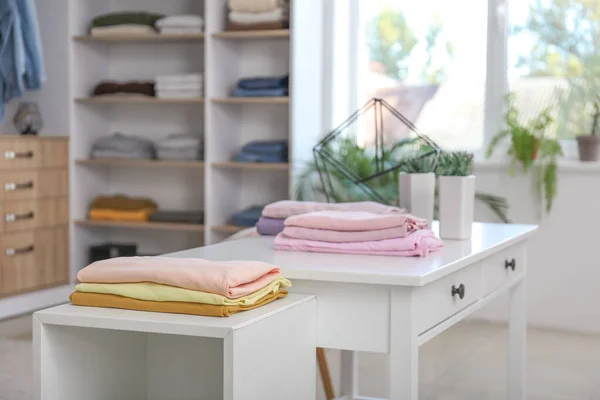 Stacked clean clothes in show room