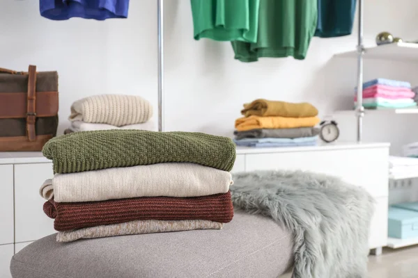 Stacked clean clothes in show room — Stock Photo, Image