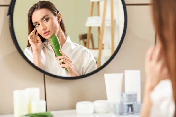 Beautiful young woman using aloe vera in bathroom — Stock Photo, Image