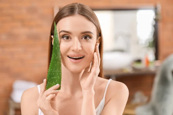 Beautiful young woman with aloe vera in bathroom — Stock Photo, Image