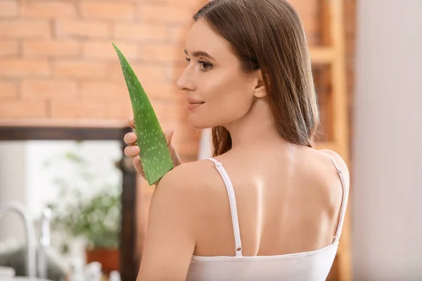 Beautiful young woman using aloe vera in bathroom — Stock Photo, Image