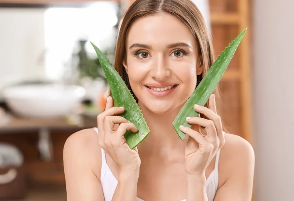 Beautiful young woman with aloe vera in bathroom — Stock Photo, Image