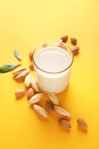 Glass of tasty almond milk on color background — Stock Photo, Image