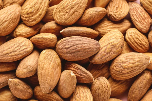 Many tasty almonds as background — Stock Photo, Image