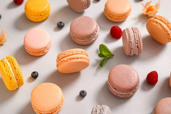 Assortment of tasty macarons on grey background — Stock Photo, Image