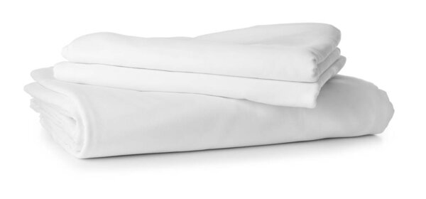 Stack of clean bed sheets on white background