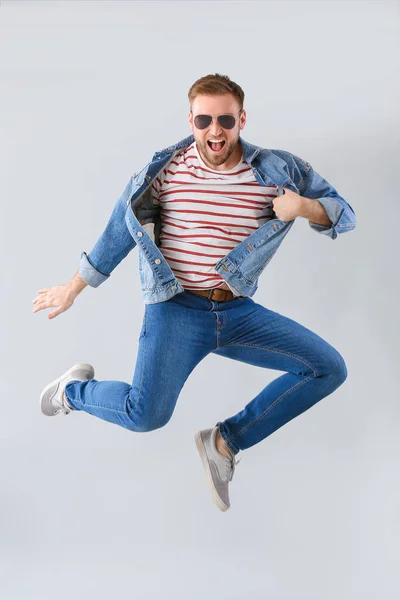 Handsome dancing man on grey background