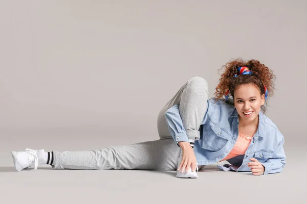 African-American hip-hop dancer on grey background