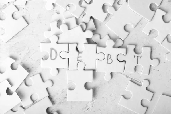 Word Debt Made Jigsaw Puzzle Pieces Light Background — Stock Photo, Image