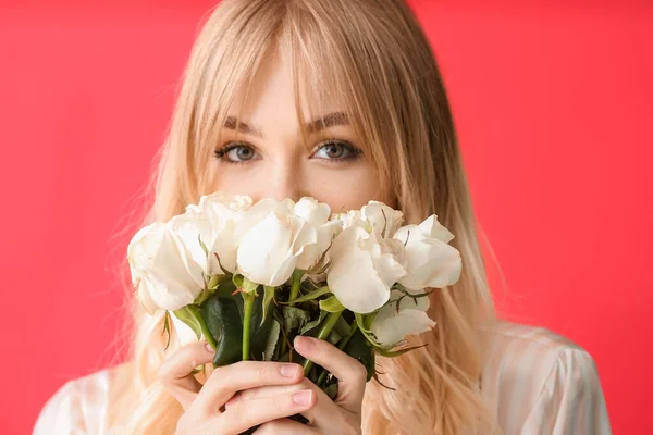 色の背景にバラの花束を持つ美しい若い女性 — ストック写真