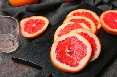 Gri arkaplanda taze kesilmiş greyfurt