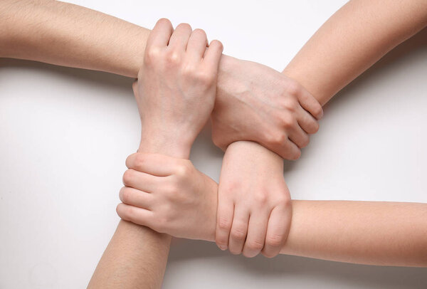 People holding hands together on white background. Unity concept