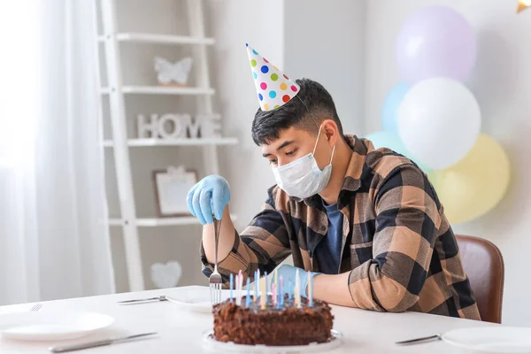 Sad Asian man celebrating Birthday without friends. Concept of epidemic