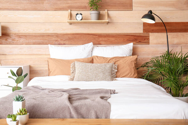 Stylish interior of room with big bed