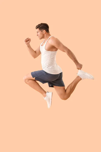 Sporty Jumping Young Man Color Background — Stock Photo, Image