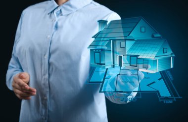 Koyu arkaplandaki binanın sanal modeline sahip kadın mimar