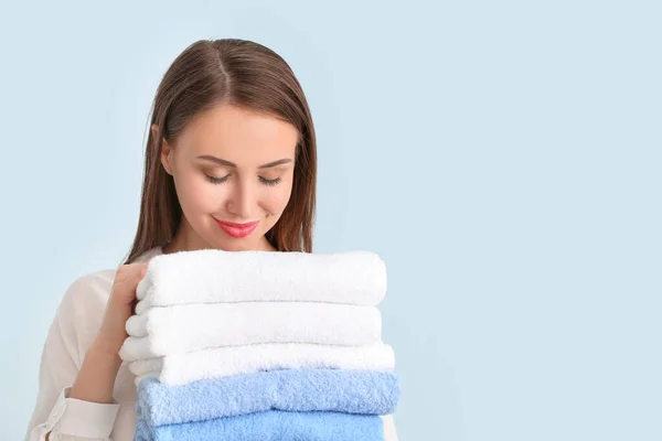Young Woman Clean Laundry Light Background — Stock Photo, Image