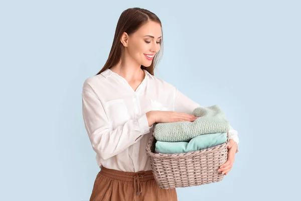 Young Woman Clean Laundry Light Background — Stock Photo, Image