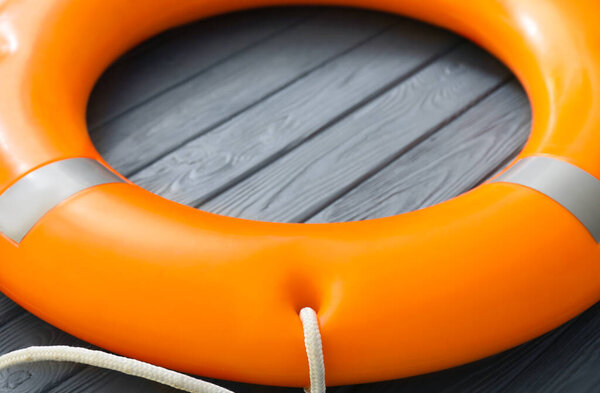 Lifebuoy ring on wooden background