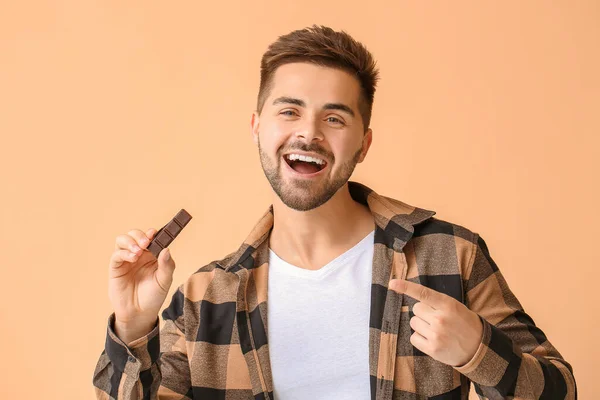 Handsome Young Man Tasty Chocolate Color Background — Stock Photo, Image