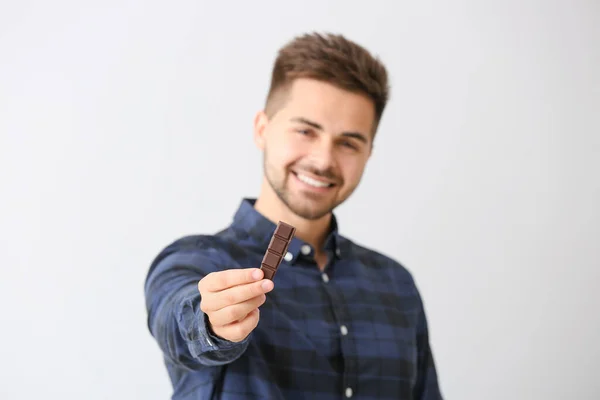 Handsome Young Man Tasty Chocolate Light Background — Stock Photo, Image