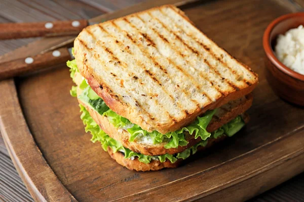 Tasty cucumber sandwich on table