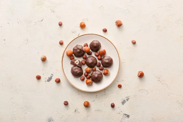 Plate Tasty Chocolate Candies Nuts White Background — Stock Photo, Image