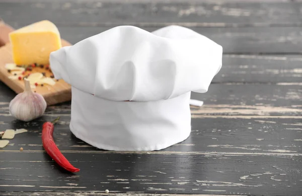 Chef\'s hat and products on table in kitchen