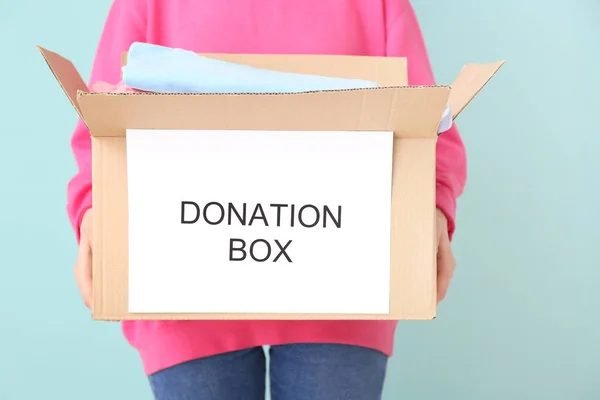 Woman Holding Box Donations Color Background — Stock Photo, Image