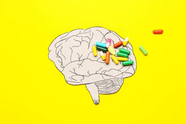 Human brain and pills on color background. Concept of dementia